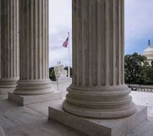 The columns of the Supreme Court are seen with the Capitol at right, in Washington, early Monday, June 15, 2020.