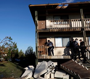 Members of an Indiana urban search and rescue team check an apartment building for residents in the aftermath of hurricane Michael in Callaway, Fla., Thursday, Oct. 11, 2018.