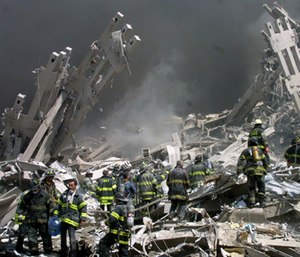 Firefighters make their way through the rubble following the 9/11 attacks.