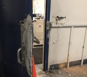 This photo shows a door damaged by rioters at Seattle Police's East Precinct.