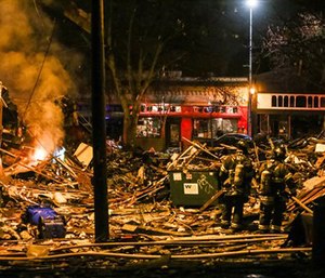 Firefighters work at the scene of a building explosion in Seattle's Greenwood neighborhood early Wednesday. (Genna Martin/seattlepi.com via AP)