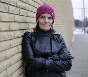 In this Tuesday, Dec. 16, 2014 photo, Windie Lazenko, with the anti-trafficking group 4her North Dakota, stands for a photo in Williston, N.D.