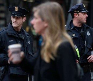 Police officers Alan Katz (left) and Chris Simpson patrol on foot at Powell and Market streets in San Francisco, Calif. (Photo/TNS)