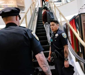 San Francisco Police Officers Nick Parkin, right, and Cory McDowell look for a person causing a disturbance in the Westfield Mall in San Francisco, California, on Wednesday, March 4, 2020. (Photo/TNS)