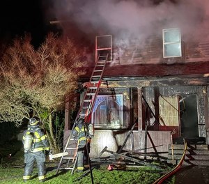 Dispatch advised firefighters that more than 20 people lived at the home and several of them were trapped on the second floor.