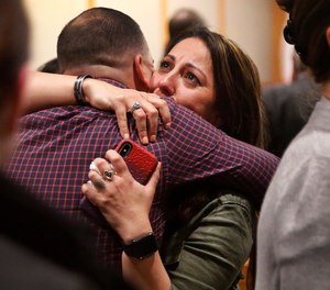 Nicole Sherrard, facing, widow of fallen Richardson police Officer David Sherrard, is hugged by family and friends after convicted murderer Brandon McCall was given a death sentence.