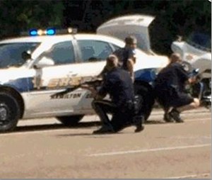 In this image made from video and released by WRCB-TV, authorities work an active shooting scene on amincola highway near the Naval Reserve Center, in Chattanooga, Tenn. on Thursday, July 16, 2015. (WRCB-TV via AP)