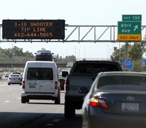 A sign still displays a shooter tip line above Interstate 10, Friday, Sept. 11, 2015, in Phoenix. (AP Image)