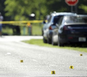 Evidence markers are placed on the street at the scene of a deadly shooting outside of the Club Blu nightclub, Monday, July 25, 2016, in Fort Myers, Fla.