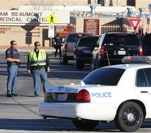 Police officers guard an entrance to the Beaumont Army Medical Center/El Paso VA campus during the search for a gunman Tuesday, Jan. 6, 2014.