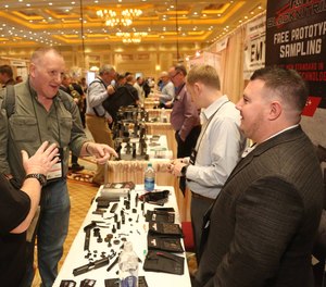 Suppliers talk with attendees at the 2019 SHOT Show in Las Vegas, Nevada.