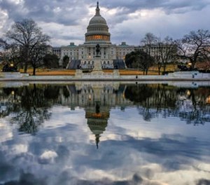 Clouds are reflected in the U.S. Capitol reflecting pool at daybreak in Washington as Day Three of the government shutdown continues, Monday, Jan. 22, 2018. (AP Photo/J. David Ake)