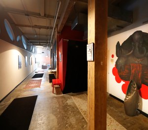 The long hallway inside Naveed Abidi's Bikram Yoga West is empty of members after being closed by the city last week, tipped off by several residents who disagreed with it being an essential health and wellness center in Chicago. (Photo/AP)