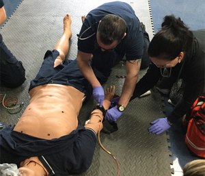 Paramedic students at Delaware Technical Community college practice hemorrhage control in a lab scenario.
