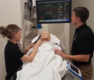 EMS students practice airway management and respiratory care with a high-fidelity patient simulator.