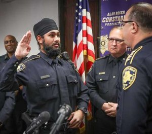 Amrit Singh, left, has been sworn in as Houston's first Sikh deputy constable.