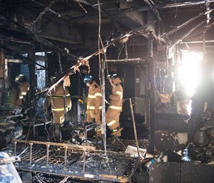 Firefighters inspect a burnt hospital after a fire in Miryang, South Korea. (Jeon Mincheol/Kookje Shinmun via AP)