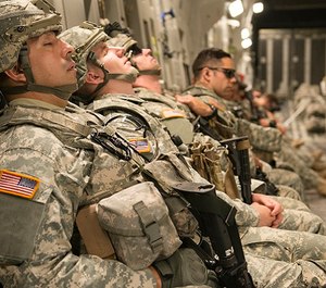 Army National Guard Soldiers catch a few minutes of sleep on board a C-17 Globemaster.