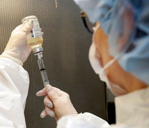 Certified pharmacy technician Peggy Gillespie fills antibiotics into a syringe for use as an I.V. push at ProMedica Toledo Hospital in Toledo, Ohio. (AP Photo/Tony Dejak)