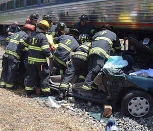 Emergency officials respond after a train and car crashed in Indianapolis. (AP Image)