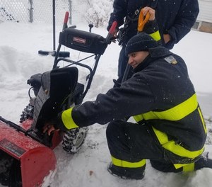 Lawrence Fire Chief Brian Moriarty posted this photograph on Twitter after firefighters rescued a man who got his hand stuck in a snowblower. The firefighters shoveled the man's driveway after he was transported to the hospital.