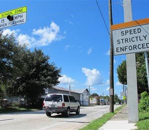 In this Aug. 29, 2014 photo, drivers enter the town of Waldo, Fla., where motorists can encounter many different speed limits in a roughly two-mile drive. The AAA auto club named the tiny town between Jacksonville and Gainesville one of only two “traffic traps” nationwide. The other town is nearby Lawtey. Now Waldo is facing a scandal over its traffic tickets.