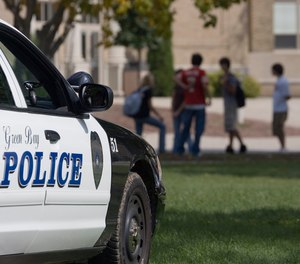 A police car sits outside Green Bay East High School Friday, Sept. 15, 2006, in Green Bay, Wis.