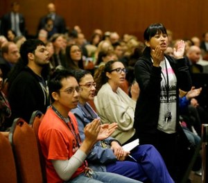 In this Nov. 19. 2014 file photo Yvette Felarca, an alumni of the University of California Berkeley and member of the group By Any Means Necessary, claps and yells as a vote is taken to raise tuition during a meeting of the University of California Board of Regents in San Francisco.