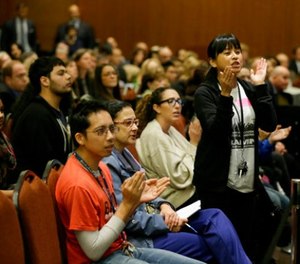 In this Nov. 19. 2014 file photo Yvette Felarca, an alumni of the University of California Berkeley and member of the group By Any Means Necessary, claps and yells as a vote is taken to raise tuition during a meeting of the University of California Board of Regents in San Francisco.