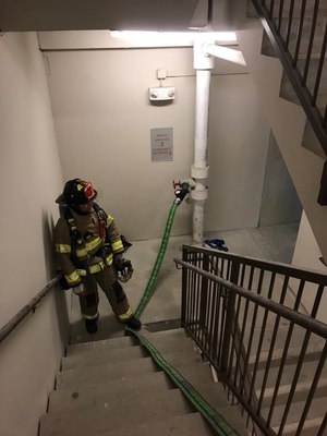 The safest, fastest and most suitable attack location is from the protection of the Type l stairwell equipped with a standpipe system. This will allow you to set up your attack package and lay it out in a controlled environment, and it gives you a place to retreat and restart if conditions overwhelm the attack team.