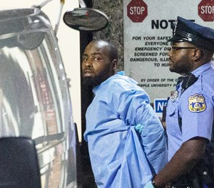 Police take shooting suspect, Maurice Hill, into custody after an hourslong standoff with police, that wounded several police officers, in Philadelphia early Thursday, Aug. 15, 2019. (Elizabeth Robertson/The Philadelphia Inquirer via AP)