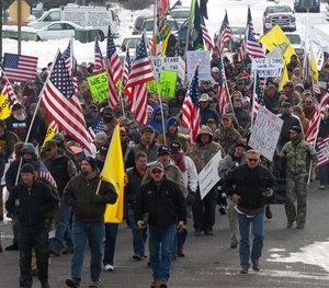 Protesters march on Court Avenue in support of an Oregon ranching family facing jail time for arson in Burns, Ore., Saturday, Jan. 2, 2016.