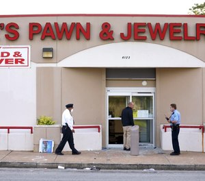 Police investigate the scene where a retired police captain was killed on Tuesday, June 2.