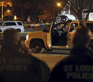 Police investigate a scene after a St. Louis police officer was shot in what the police chief called an 