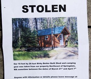 A notice sign for the Hempel's stolen cabin is displayed on Wednesday, April 8, 2015, near Springdale, Wash.