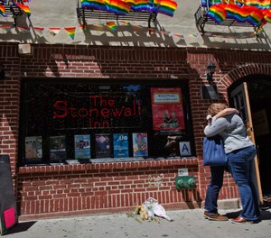 A couple embraces outside the Stonewall Inn in New York