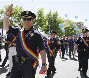 SF Police Chief Greg Suhr waves while marching with a number of his cops in the 44th annual Gay Pride parade Sunday, June 29, 2014.