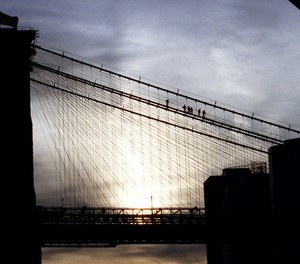 New York City Police Department Emergency Service personnel remove an attempted suicide victim from the Brooklyn Bridge, Wednesday, Nov. 25, 1998.