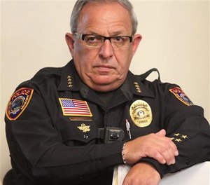 In this Oct. 20, 2015 photo, Bay St. Louis Chief of Police Michael DeNardo listens during a city council meeting in Bay St. Louis, Miss.
