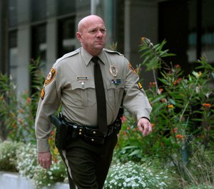 St. Louis County police Sgt. Keith Wildhaber returns from a lunch break to the St. Louis County courthouse on the third day of his discrimination case against the county in Clayton, Mo. (Photo/AP)