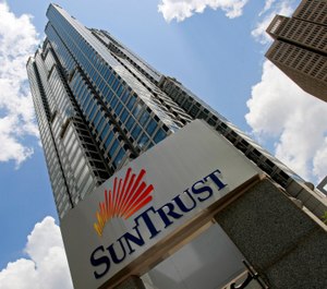 This May 7, 2009, file photo shows the SunTrust headquarters building in Atlanta. (AP Photo/John Bazemore, File)