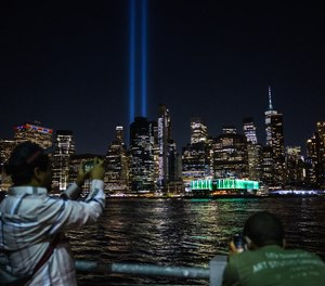 The Tribute in Lights is seen over the Manhattan skyline from Brooklyn Bridge Park as the lights are tested on Sept. 6, 2023, in New York City.