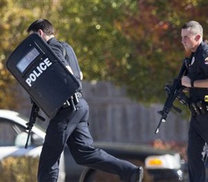 Police respond to a call of a shooting in Brookfield, Wis., were multiple people were wounded when someone opened fire at a spa.