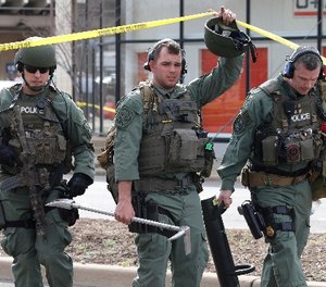 Richmond SWAT team members leave a Greyhound bus station Thursday, March 31, 2016 in Richmond, Va.