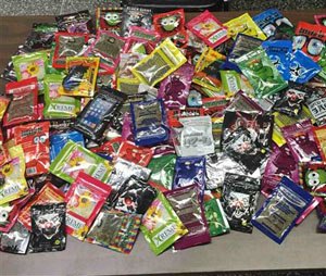 This photo provided Friday, Aug. 7, 2015 by New York Police Department shows packets of synthetic marijuana seized after a search warrant was served at a newsstand in Brooklyn, N.Y. (AP Photo/New York Police Department)
