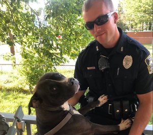 Officer James Nowodworski with a dog he saved from a house fire July 16, 2020 in Cicero, New York. (Photo/Syracuse Police Department)