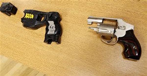 A Taser and handgun, similar to the weapons in possession of Reserve Deputy Robert Bates during a pursuit of Eric Harris, are displayed.