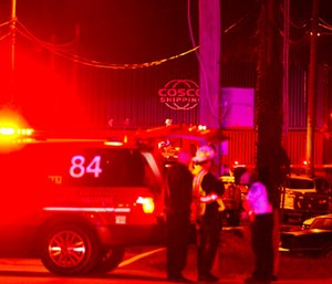 First responders stand at the scene of a train derailment involving dozens of rail cars in North Knoxville, Tenn.