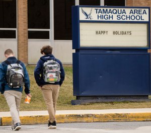Students walk to Tamaqua Area High School in Tamaqua, Pa., Friday, Jan. 4, 2019. Parents are going to court to block the Pennsylvania school district from allowing teachers to carry guns in school. (AP Photo/Matt Rourke)