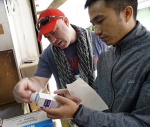 Army veteran and paramedic Jonah Thompson secures medical supplies during the Nepal Earthquake response.